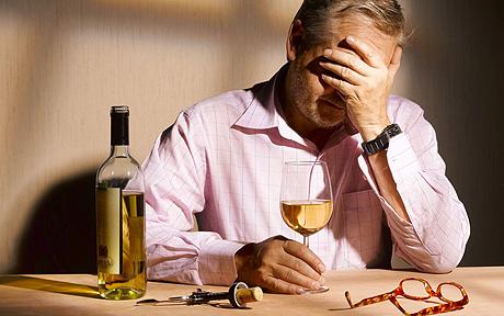 83385944 Unhappy man with a glass of wine